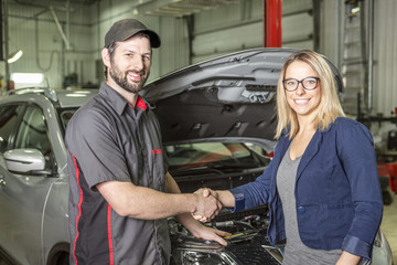 auto mechanic and female customer in garage