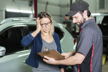 auto mechanic and female customer in garage