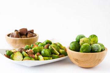 Brussels sprouts with chestnuts and bacon isolated on white background
