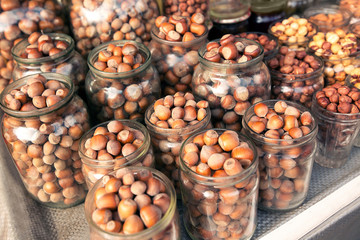 Hazelnuts in the bowl on Hazelnut background