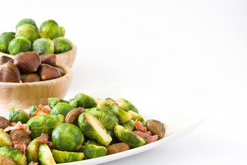 Brussels sprouts with chestnuts and bacon isolated on white background
