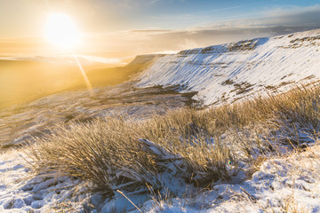 Winter snowy landscape at sunrise in Wales