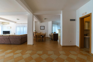 Interior of a living room with kitchen zone in a villa