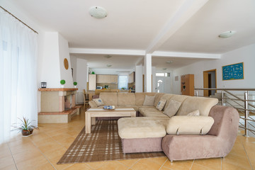Interior of a living room with kitchen zone in a villa