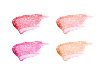 Different lip glosses isolated on white. Smudged lip gloss sample.
