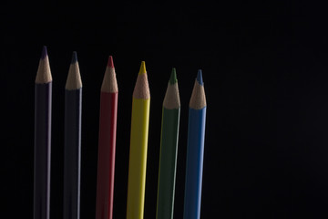 set of colour pencils isolated on black background
