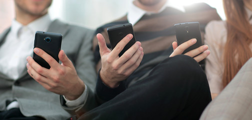 Group of young people use their phones