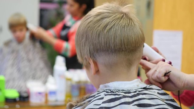 child's haircut at the Barber shop.looking at yourself in the mirror