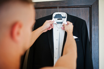 Man wearing shirt and jacket. Groom morning at wedding day.