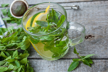 Mint tea with lemon, mint and tea strainer. Winter warming soothing drink.