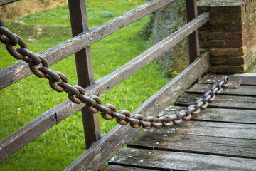 large iron chain on an old castle bridge