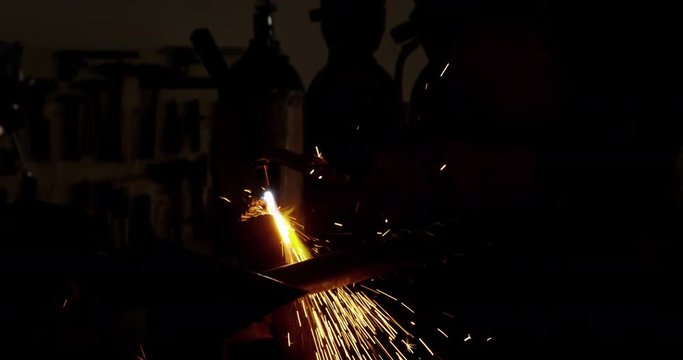 Welder holding welding torch