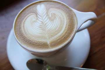 cappuccino coffee on wood background