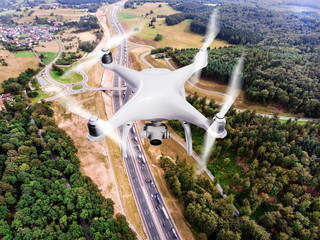 Hovering drone taking pictures of highway in forest, Netherlands