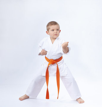 In the rack of karate is standing a small athlete