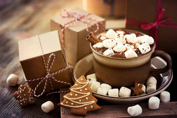 Hot cacao drink with marshmallows, gift box and christmas cookie