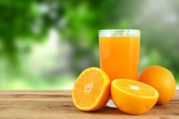 Orange juice and oranges on wooden table.
