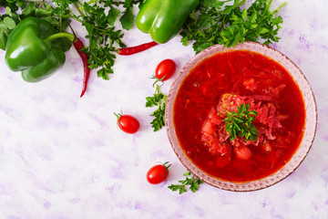Traditional Ukrainian Russian vegetable borscht soup on light background. Top view