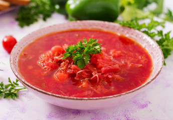 Traditional Ukrainian Russian vegetable borscht soup on light background