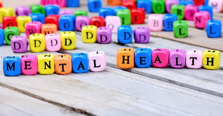 Mental Health words on wooden table