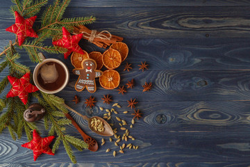 Christmas gingerbread cookies with icing, cup of tea, fir-tree b