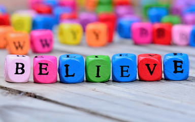 Believe word on wooden table