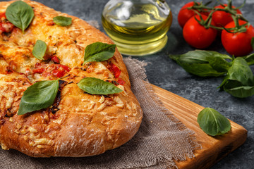 Focaccia with tomatoes, herbs and cheese.