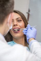 Female patient open her mouth during treatment