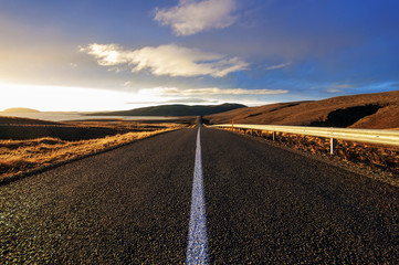 Straight road across the desert in Iceland, Sunset HDR