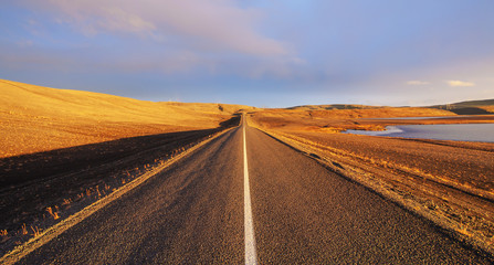Fototapeta na wymiar Straight road across the desert in Iceland, Sunset HDR