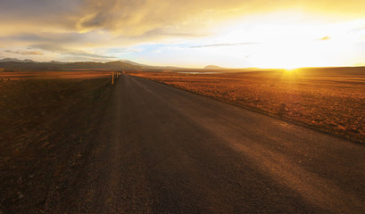 Straight road across the desert in Iceland, Sunset HDR