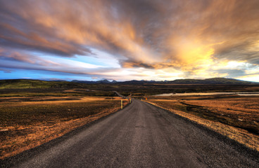 Asphalt road across the desert in Iceland, Sunset HDR