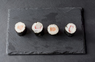 Pieces of sushi on a black stone