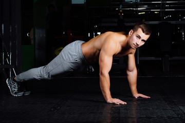 Fototapeta na wymiar Men with battle rope in functional training fitness gym