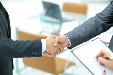 Successful handshake of business men in a working environment