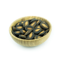 Watermelon seeds in wood bowl isolated on white background