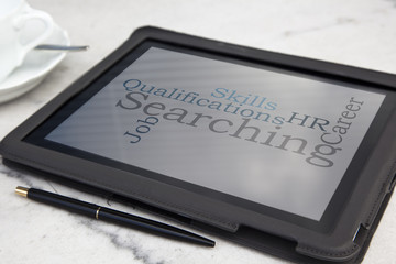 tablet with staff searching word cloud
