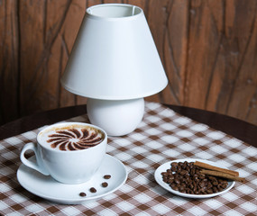 cappuccino cup with beans on the table