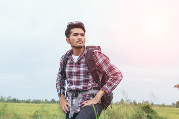 Young Man Traveler with backpack relaxing outdoor.