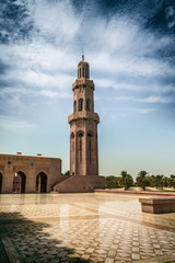 Fototapeta na wymiar Solitary tall stone minaret with domed top