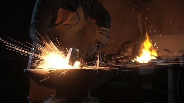 Forging hot metal in smithy