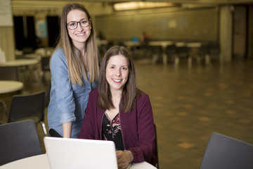 pretty female college student studying in the university library