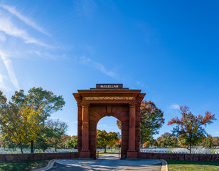 Fototapeta na wymiar McClellan Gate Arlington National Cemetery Graves Blue Sky Dayti