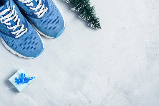 Christmas sport composition with shoes, and blue gift box