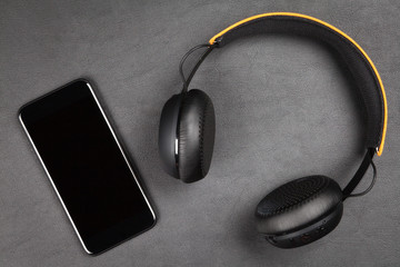 Black modern smartphone and headphones