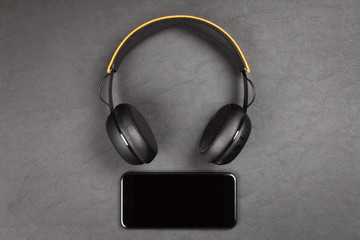Black modern smartphone and headphones