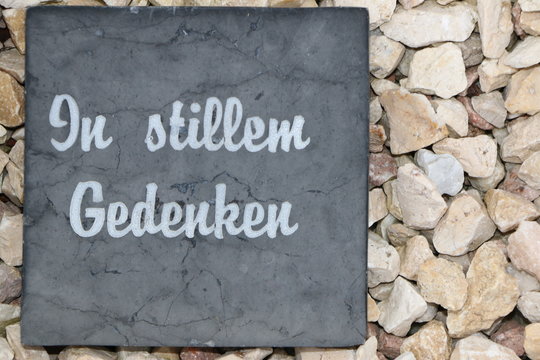 German sign "In silent Memory" in a cemetery, minimalistische Grabgestaltung