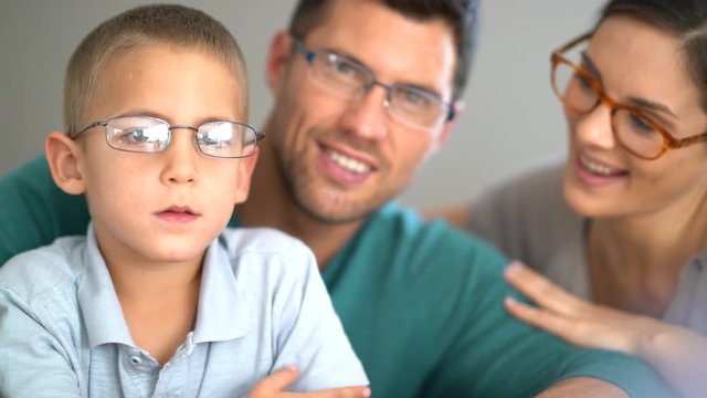 Family of three people wearing eyeglasses
