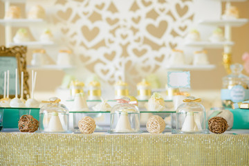 Delicious cakes in glass vessels at the festive candy bar