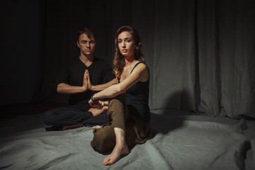 Young woman and young man practice yoga